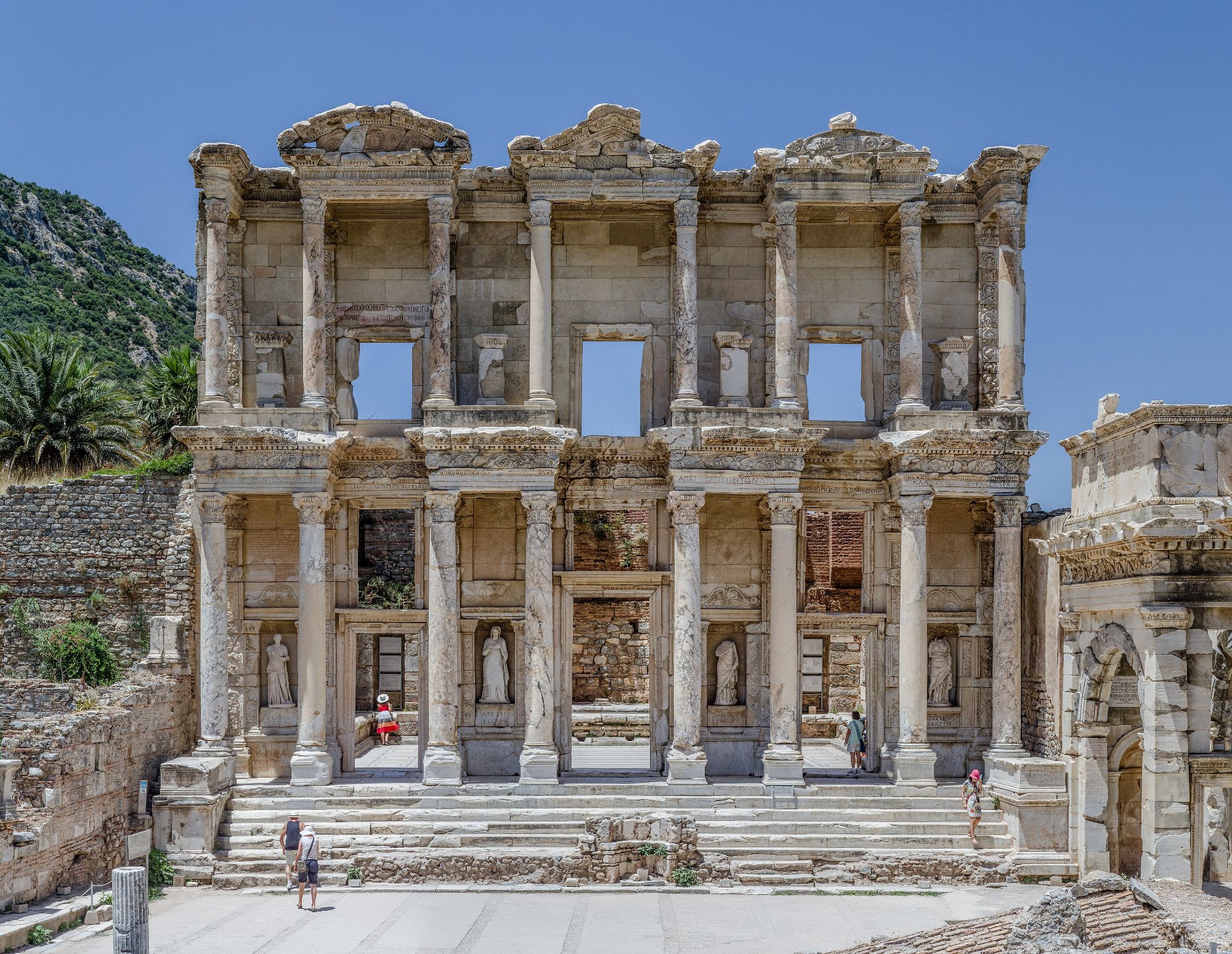 The Library of Celsus at Ephesus, its two-storey marble facade glowing under a blue sky