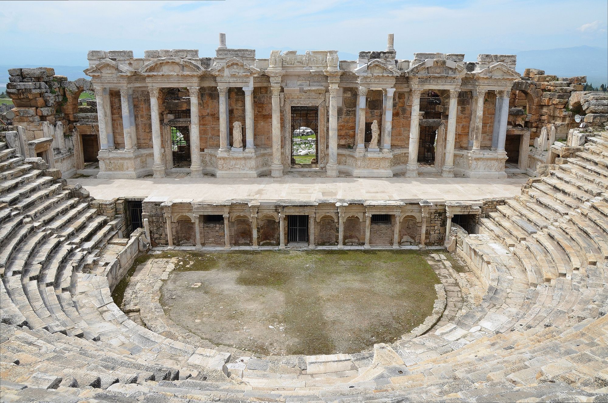 The restored Roman theatre of Hierapolis, tiers of stone seats facing an ornate stage building